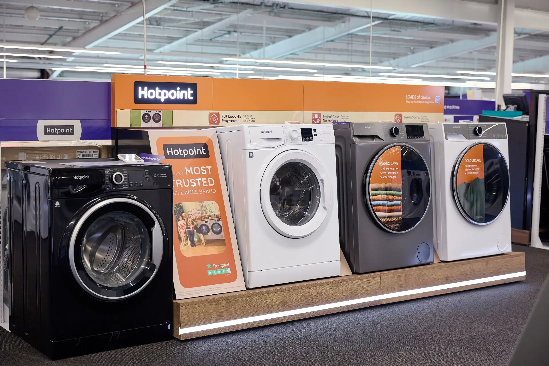 Hotpoint washing machines on display in Currys with branded signage and promotional point of sale