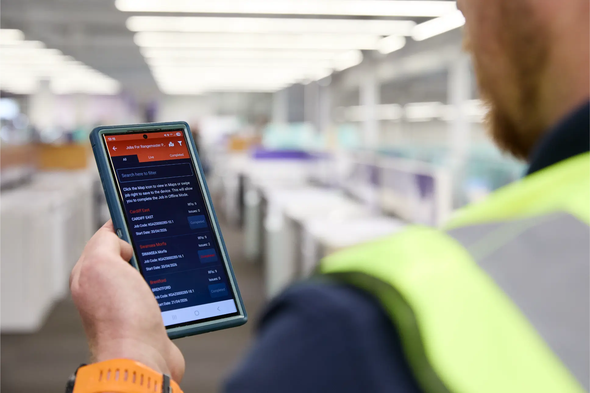 SJH engineer in a Currys store using a mobile app to track installation jobs and progress on site
